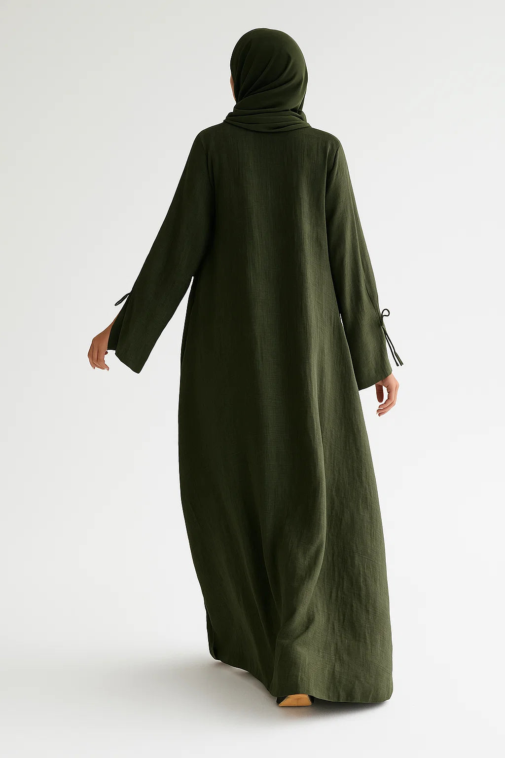 Person wearing an olive green abaya and hijab on a white background